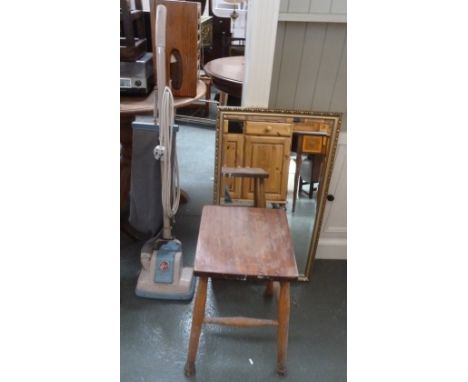 A bevelled wall mirror with gilt frame, a vintage pine kitchen stool and a 1950s Hoover vacuum cleaner