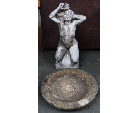 A stone garden statue of a naked woman washing herself with a shell, 63cmH, together with a stone bird bath basin, 44cmD