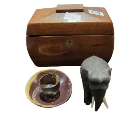 A 19th Century mahogany sarcophagus shaped tea caddy, an elephant ornament and a hardstone egg cup and saucer