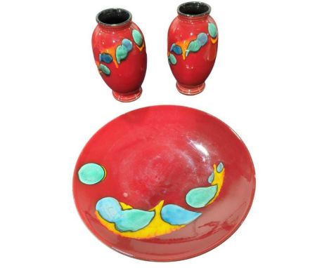 A Poole charger and a matching pair of vases, charger 40cms diam vases 27cms high