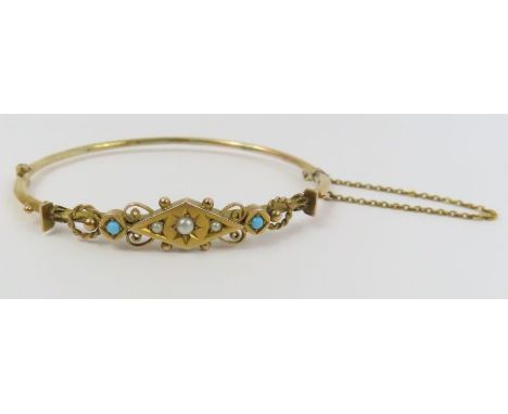 An Edwardian hinged bangle, set with simulated pearls and turquoise, marked '9ct', with safety chain, 5.9cm internal diameter