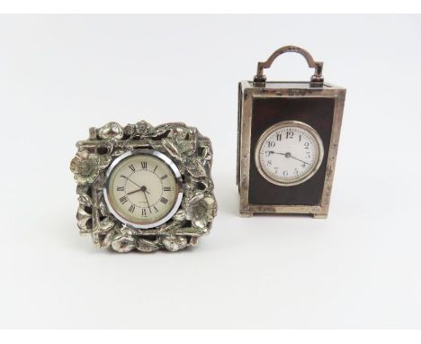 An early 20th Century tortoiseshell and silver travelling timepiece having circular white enamel dial, French movement, 10cms