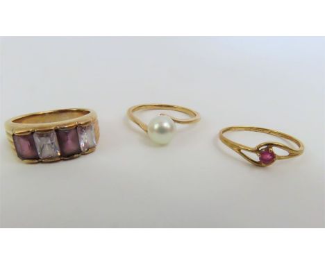 A single stone ruby ring, marked '750', finger size N, 0.9g gross; a cultured freshwater pearl dress ring, marked '10k', fing