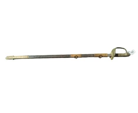 A Royal Navy sword with brass lions head pommel, wire bound shagreen grip, blade marked for Gieves and with etched detail in 