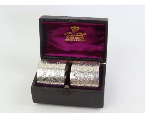 A pair of Victorian silver engraved napkin rings, London 1889, John Newton Mappin (Mappin &amp; Webb), cased, 49 grams 