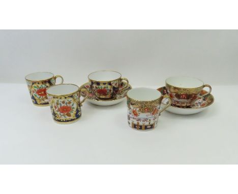 An early 19th Century Spode 1216 cup and saucer and two coffee cans all painted in strong Imari pattern and a Spode trio 967