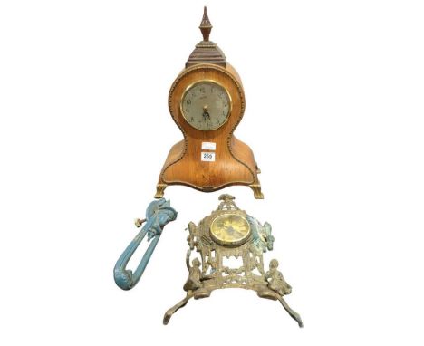 A battery operated mantel timepiece in decorative wood case, a late 19th Century cast metal door knocker and a timepiece in d