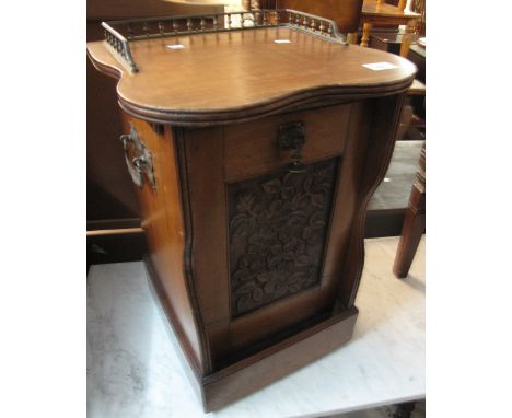 Edwardian mahogany fireside coal box or pedonian with brass gallery, carrying handles and foliate carved panel.