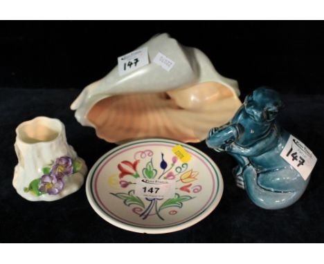 Poole pottery shell ornament, pin dish, otter and Royal Worcester tree stump with floral decoration. (4)