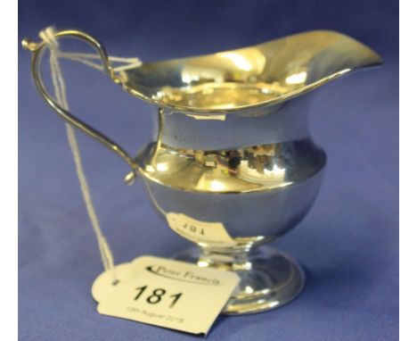 Small silver, helmet shaped cream jug, Birmingham hallmarks.