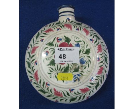 Swansea style foliate painted pottery flask of circular form.