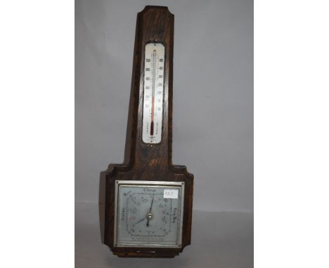 A mid century Smiths oak wall mounted barometer.