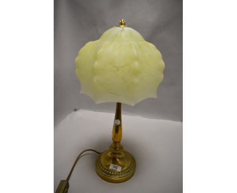 An art deco era table lamp having brass base with mottled yellow and cream glass shade