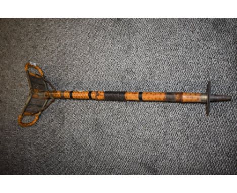 A campaign or safari style shooting stick having heavy bamboo frame with rattan seat