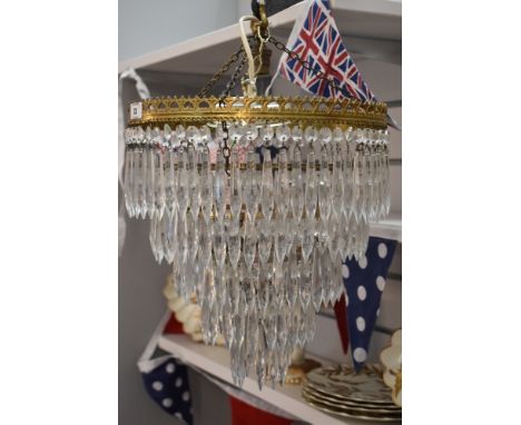 An ormolu framed and glass chandelier light pendant having lustre glass ,
measures 30cm accross