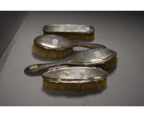 A set of HM silver Edwardian dressing table brushes in various designs