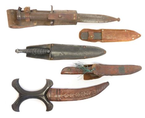 Collection of knives, to include a Fairbairn Sykes dagger, a Hadendoa warrior's dagger, curved double edged blade, sculpted '