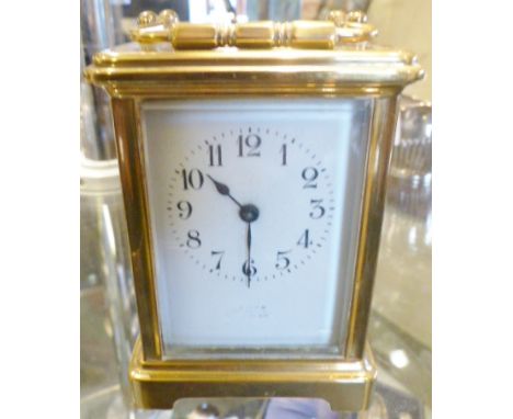 CARRIAGE CLOCK. Brass carriage clock with Arabic numerals to dial