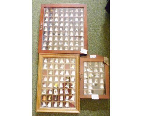 CERAMIC THIMBLES. Three display cases of ceramic thimbles