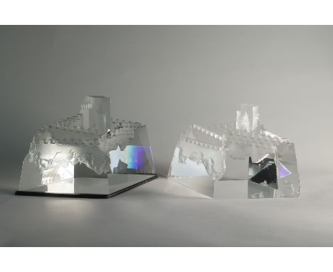 Two sculptures of Steuben's Castle of Dreams. The piece is created with perfectly cut angles and balanced with the raw crysta