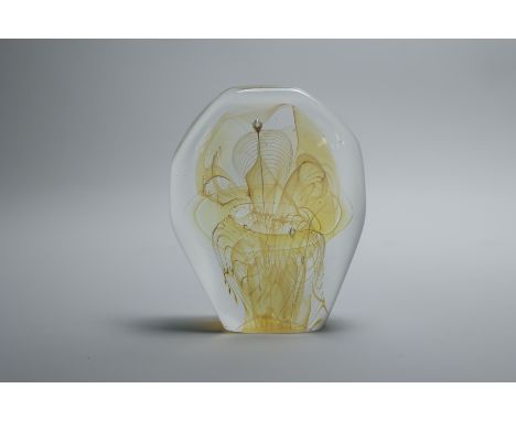 The sculpture has yellow accents and iridescence inside the clear glass that swirls like smoke. Placed air bubbles add to the