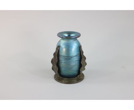 A metallic blue with hints of purples Tiffany's Studio Favrile glass vase.The vase has an egg-shaped body and a short neck. W