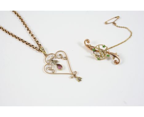 A 15CT. GOLD SWALLOW BROOCH the swallow set with graduated half pearls within a surround of four demantoid garnets, 4cm. long