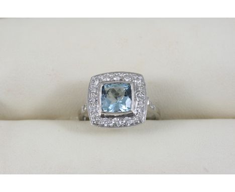 AN AQUAMARINE AND DIAMOND CLUSTER RING the square-cut aquamarine is set within a surround of circular-cut diamonds, with furt