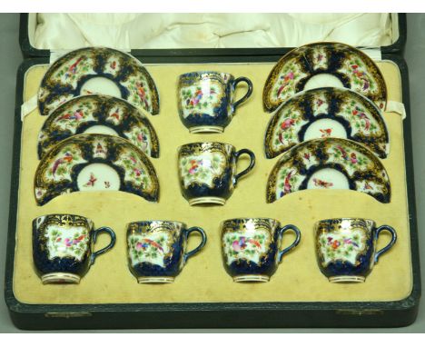 A ROYAL WORCESTER COFFEE SET decorated with gilt cartouches on a blue scale ground, printed and painted marks (cased).