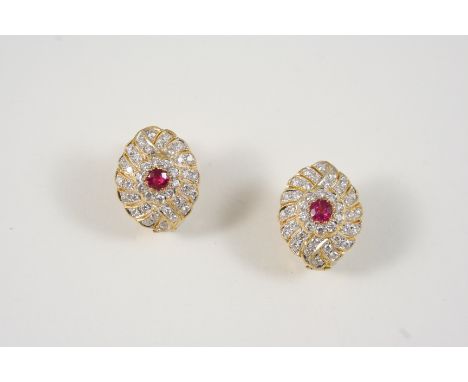 A PAIR OF RUBY AND DIAMOND FLOWER HEAD EARRINGS each centred with a circular-cut ruby within a surround of circular-cut diamo