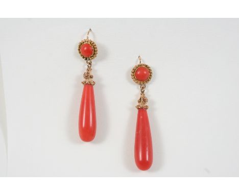A PAIR OF CORAL DROP EARRINGS each formed with a coral baton, with circular coral and gold surmount, 5.5cm. long.