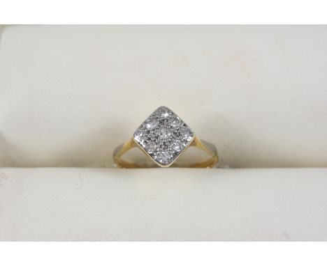 A DIAMOND CLUSTER RING the plaque-shaped ring is millegrain set with eight-cut diamonds, in gold. Size K.