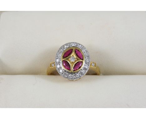 A DIAMOND AND RUBY CLUSTER RING centred with four marquise-shaped rubies and a small diamond within a surround of circular-cu