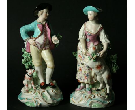 A PAIR OF DERBY SHEPHERD FIGURES late 18th Century on scrolling bases, patch marks. Height 21cm. (2).