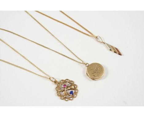 A 9CT. GOLD CIRCULAR LOCKET PENDANT with engraved decoration to the front case, together with two other 9ct. gold pendants, a