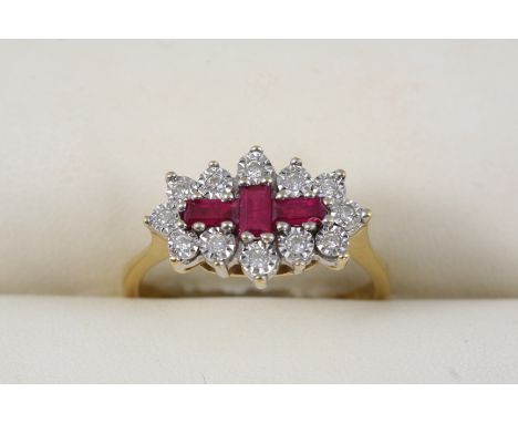 A RUBY AND DIAMOND CLUSTER RING centred with three rectangular-shaped rubies within a surround of circular-cut diamonds, in 1