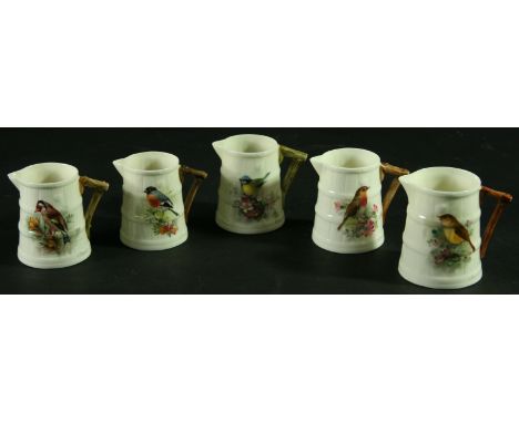 A COLLECTION OF FIVE ROYAL WORCESTER JUGS, signed Powell, date ciphers for 1916 and later, painted with a bullfinch, bluetit,