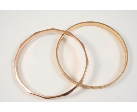 A 9CT. GOLD BANGLE with engraved floral decoration, 7.2 grams, together with a gold plated floral engraved bangle.