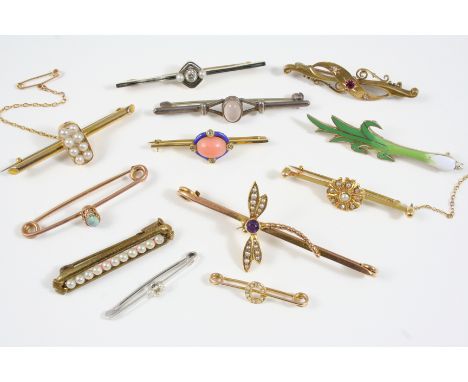 TWELVE ASSORTED GOLD AND GEM SET BROOCHES including one formed as a dragonfly and set with an amethyst and small pearls, one 