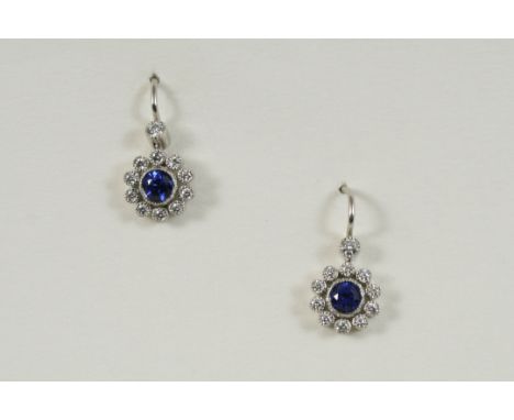 A PAIR OF SAPPHIRE AND DIAMOND CLUSTER EARRINGS BY TIFFANY & CO. each set with a circular-cut sapphire within a surround of c