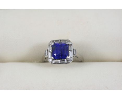 AN ART DECO SAPPHIRE AND DIAMOND RING the square-shaped sapphire is set within a surround of baguette-cut diamonds, with a si