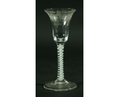 AN EIGHTEENTH CENTURY WINE GLASS, the bell shaped bowl with engraved fruiting vine and bird decoration, above a multistrand, 