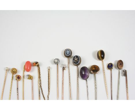 SIXTEEN ASSORTED GOLD AND GEM SET STICK PINS including a blue enamel one set with rose-cut diamond floral decoration, one set