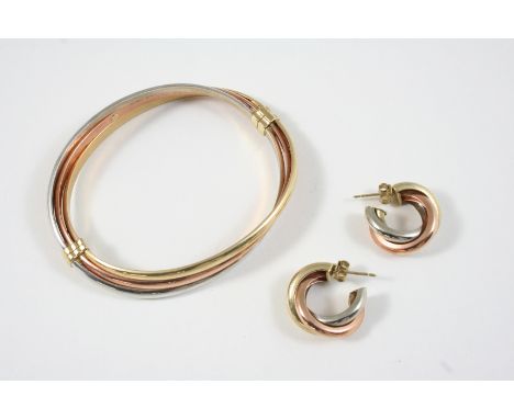A 9CT. THREE COLOUR GOLD HALF HINGED BANGLE 11 grams, together with a pair of 9ct. three colour gold hoop earrings, 4.3 grams