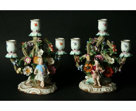 A PAIR OF MEISSEN THREE-LIGHT CANDELABRA late 19th Century, modelled as children before floral encrusted branches. Incised '1