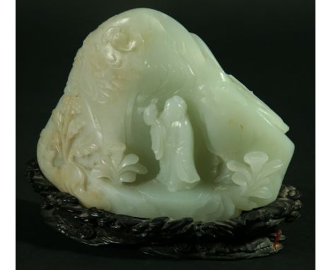 A CHINESE CELADON JADE BOULDER CARVING, with hints of russet, a traveller standing before a tree and plants with bats flying 