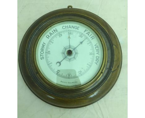 A circular wood framed barometer