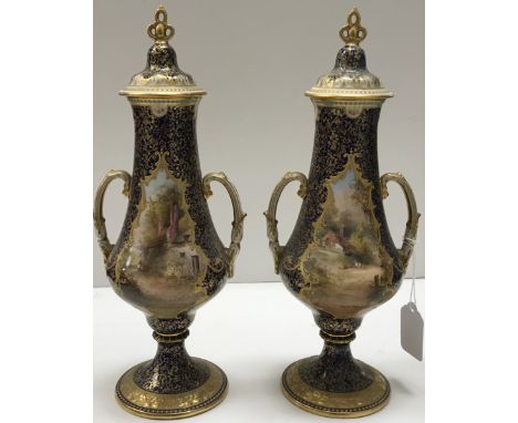 A pair of Royal Doulton blue and gilt ground hand-painted urn shaped vases and covers, the panels decorated with rural scenes
