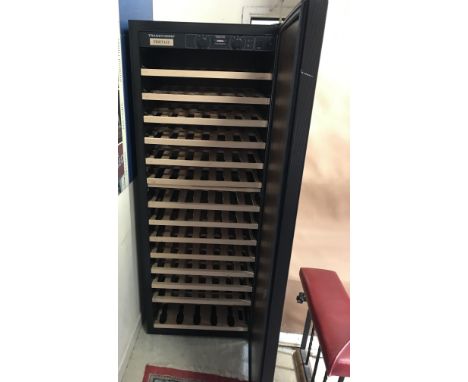 A Transtherm Ermitage 182 bottle wine fridge with faux oak veneers, 68 cm wide x 63.5 cm deep x 180.5 cm high