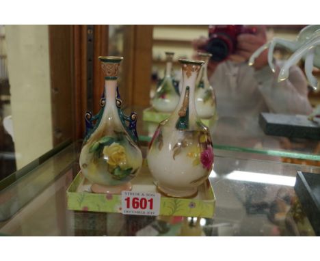 Two small Royal Worcester twin handled vases,&nbsp;circa 1911 and 1907, each painted with roses, each approx 12cm high. 